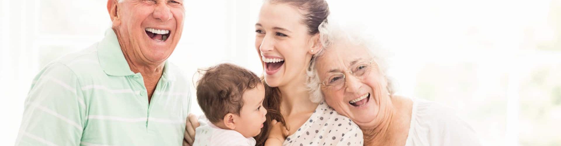 Happy grandparents playing with their grandson at home