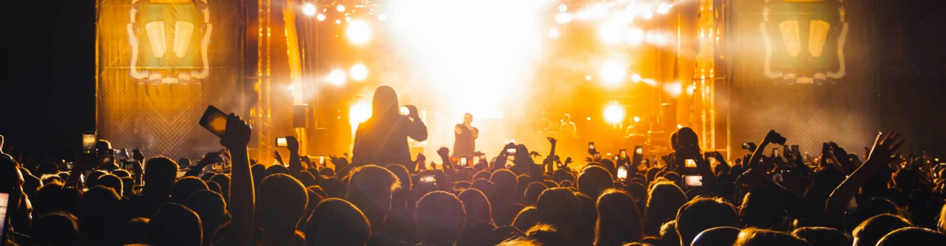 KINESHMA, RUSSIA - AUGUST 30, 2018: Live concert of the popular Russian rap singer Basta on stage from the label Gazgolder. Silhouettes of the audience on a musical night performance