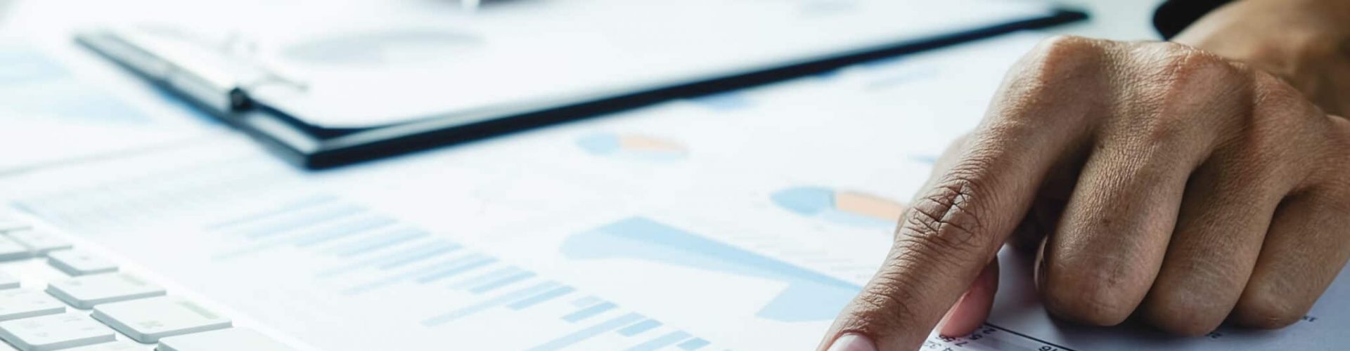 Asian business woman analyzing investment charts on desk. Vintage tone Retro filter effect,soft focus,low light.(selective focus).